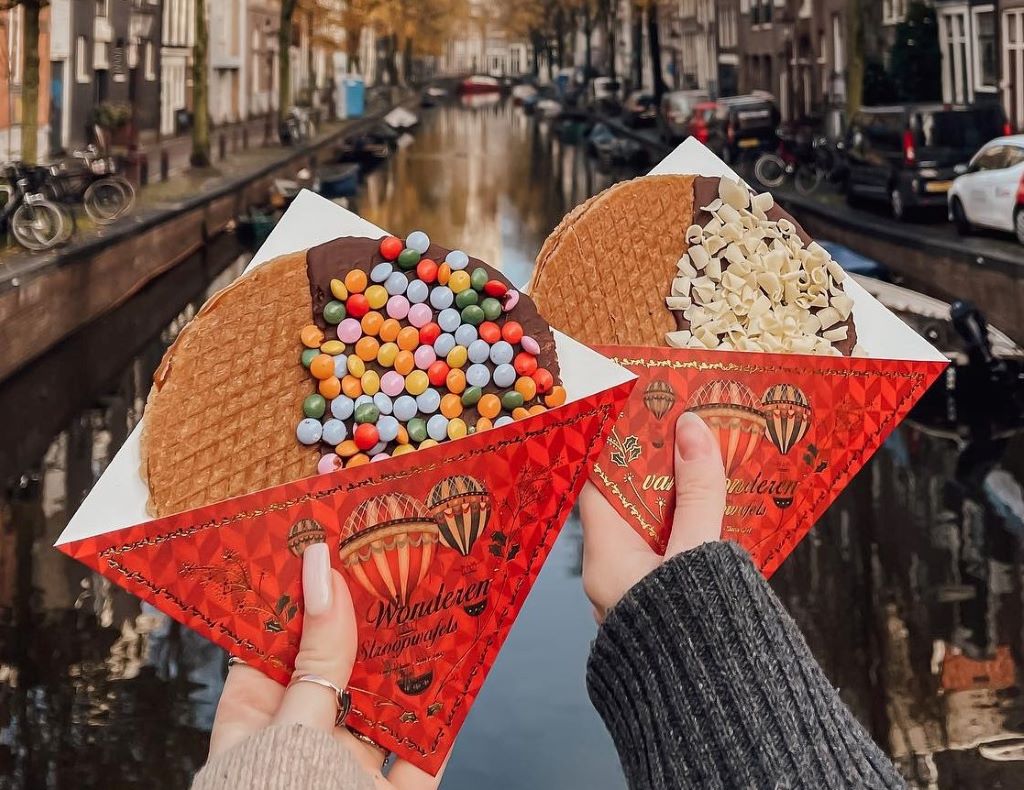 photo of two stroopwafels by canal in amsterdam netherlands