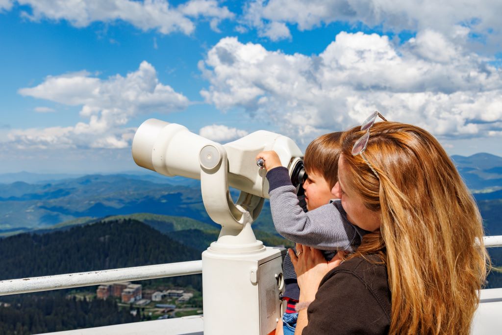 photo of a woman and boy looking at a landscape through a telescope in bulgaria