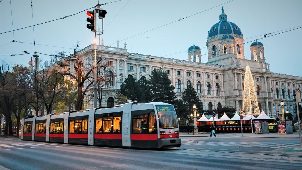 photo of a red and white tram in vienna austria