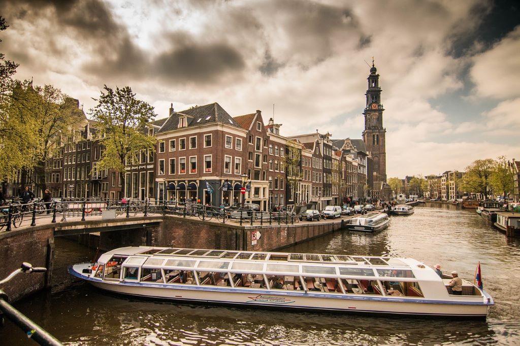 photo of a tourist boat on a canal in amsterdam netherlands