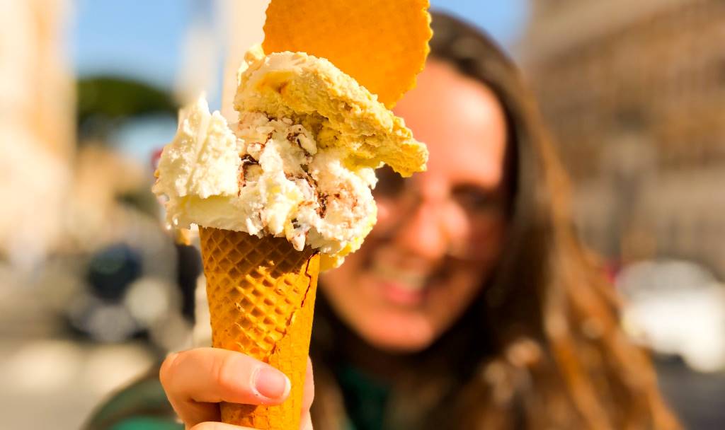 an image of a girl in rome italy holding an ice cream