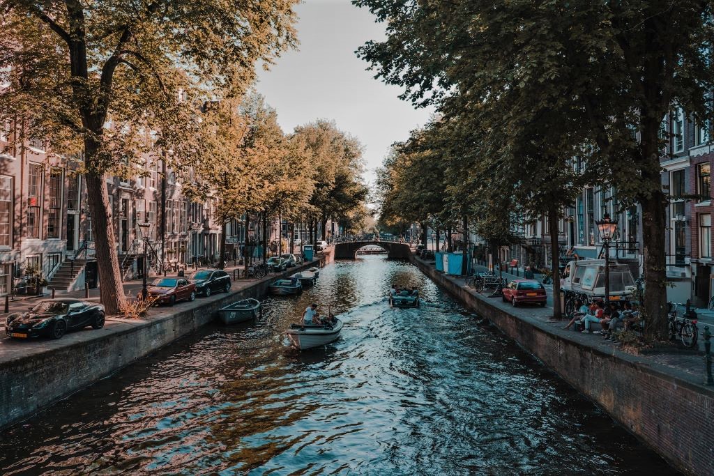 photo of boats in a canal in amsterdam netherlands