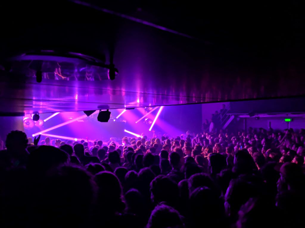 photo of a party with purple lights in a club in amsterdam netherlands