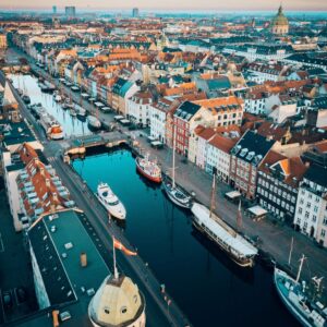 photo of the city of copenhagen denmark from the air, river city buildings boats