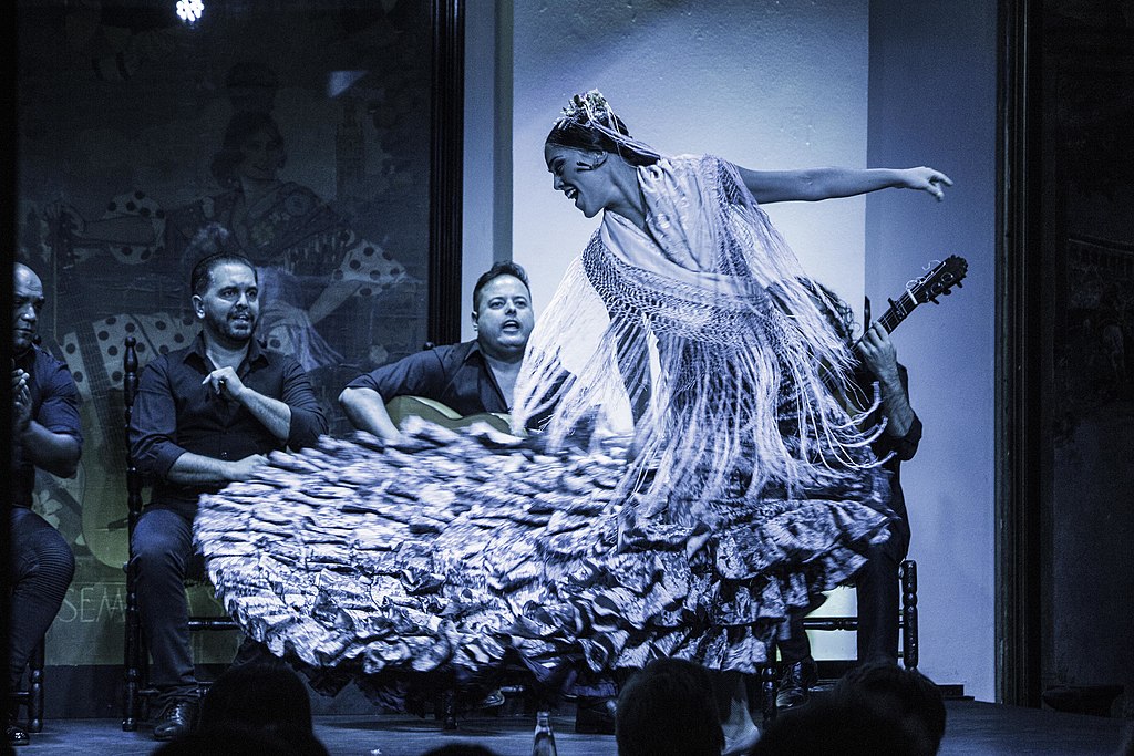 A flamenco dancer with musicians in the background in Seville, Spain