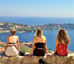 photo of three women looking down on an ocean bay in nice france