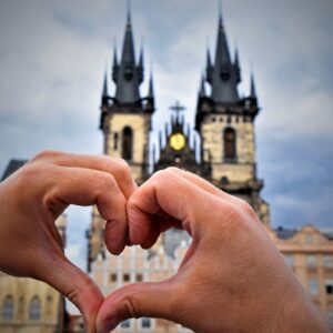 photo of hands arranged in a heart shape over prague czech republic