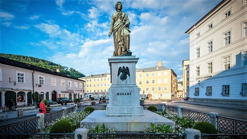 photo of a statue of mozart in a town square in salzburg austria
