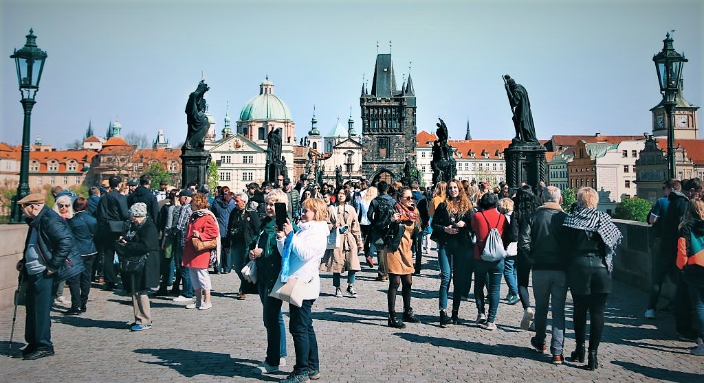 photo of tourists on a stone bridge in prague czech republic