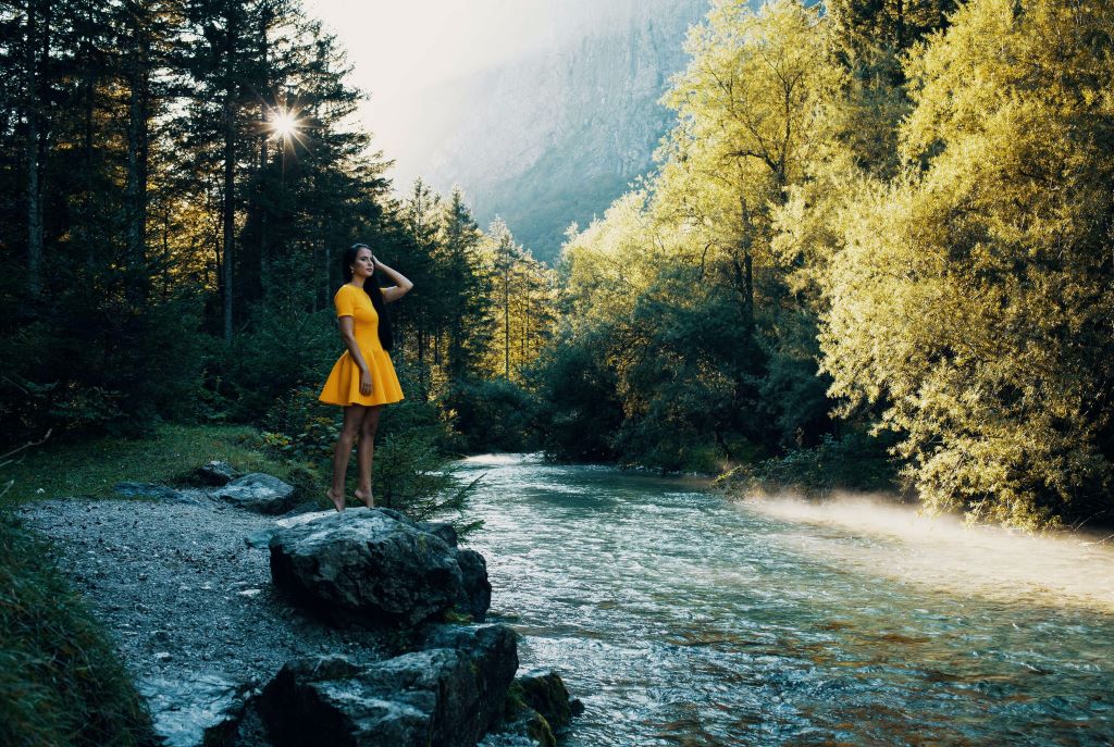 photo of a girl in yellow dress by a river in salzburg austria