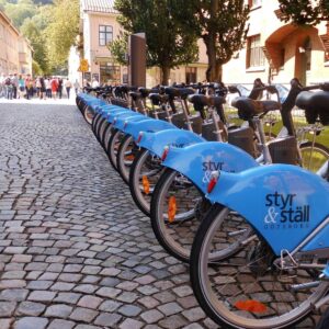 photo of blue bicycles on a cobbled street in gothenburg sweden