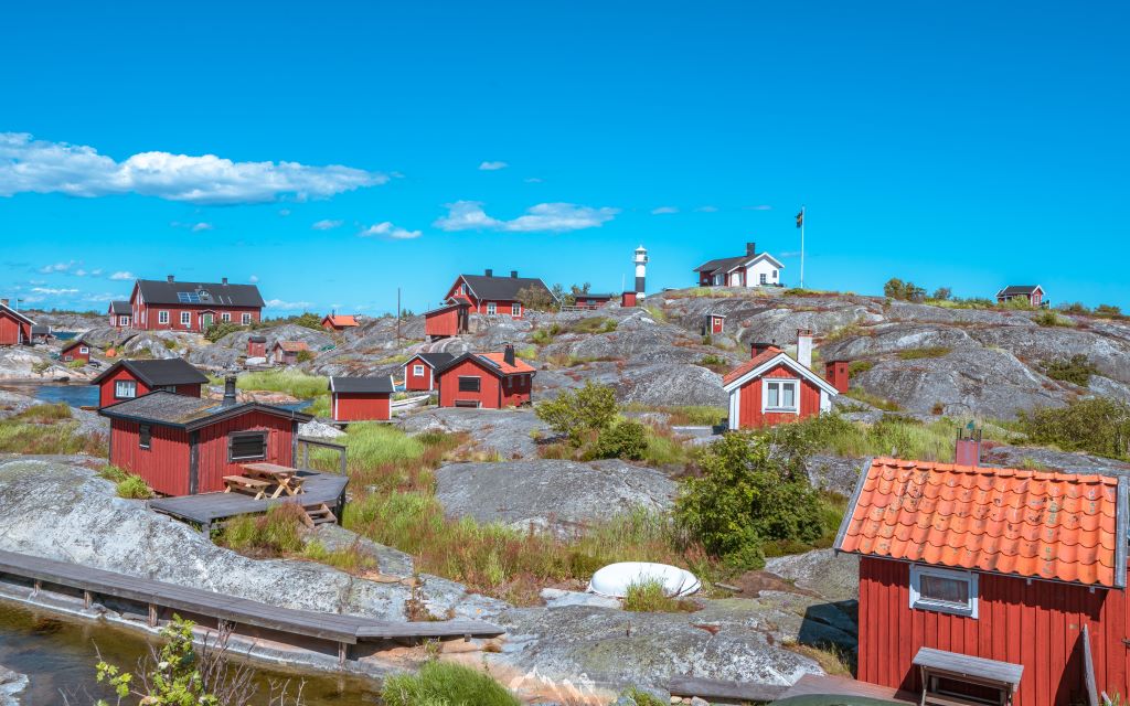 photo of red cabins in a landscape in stockholm sweden