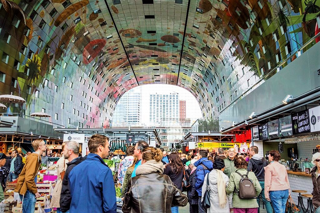 photo of crowds inside a large market with art on ceiling in rotterdam netherlands
